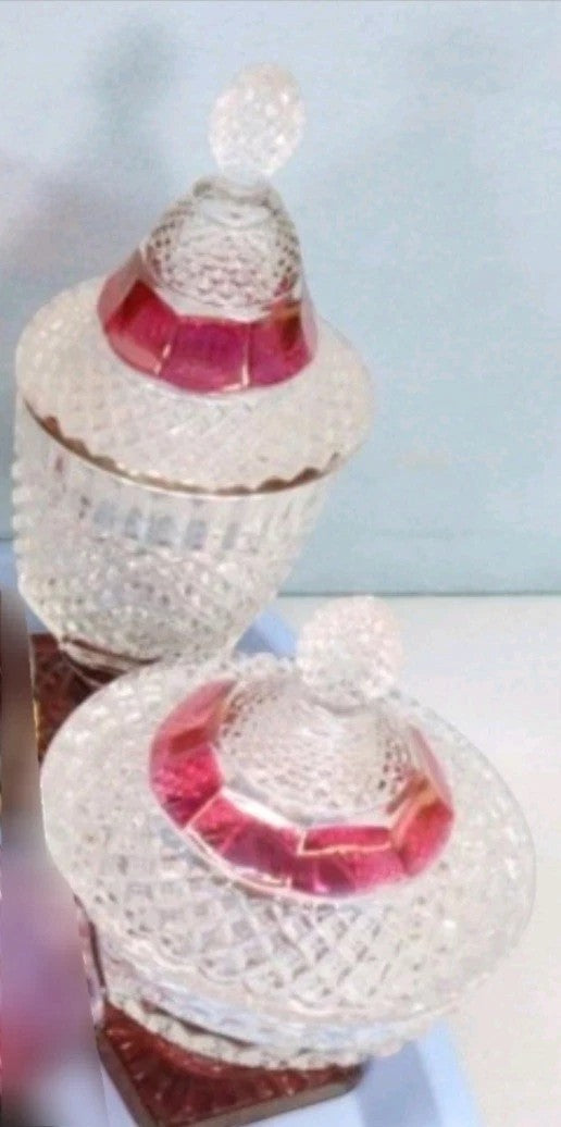 Two Westmoreland English Hobnail ruby flash footed candy dishes with lids. Clear glass with hobnail texture and ruby red accents.