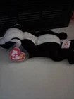 Back Road Vintage Valuables Stinky Beanie Baby skunk plush toy, black and white with pink heart tag.
